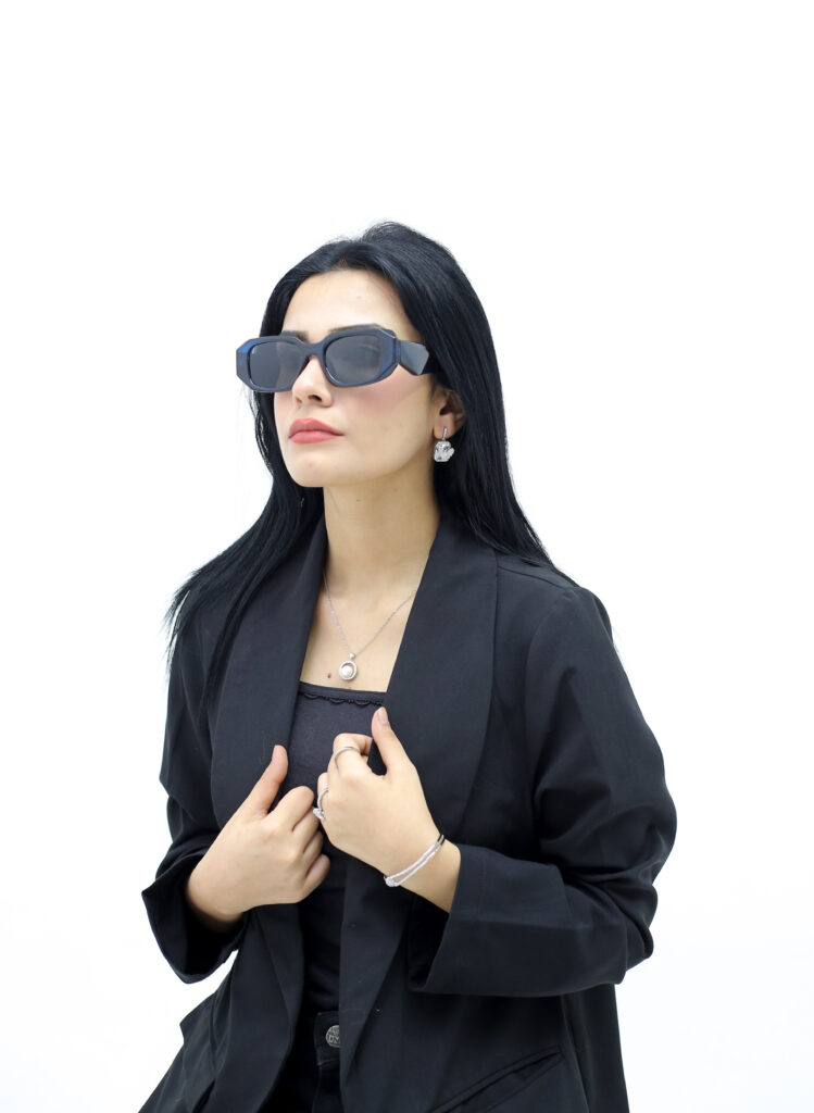 girl wearing black sunglasses with black coat dress