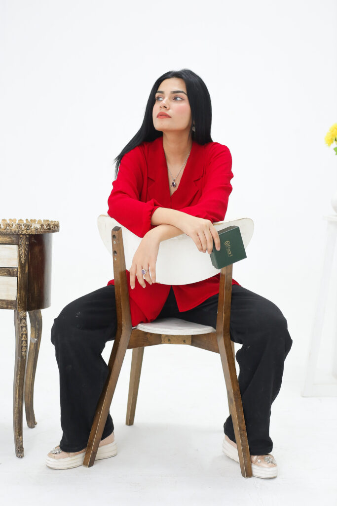 girl sitting on chair with red shirt moderling fashion